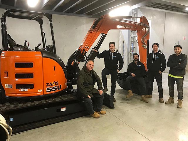 Some of our team with our Hitachi excavator